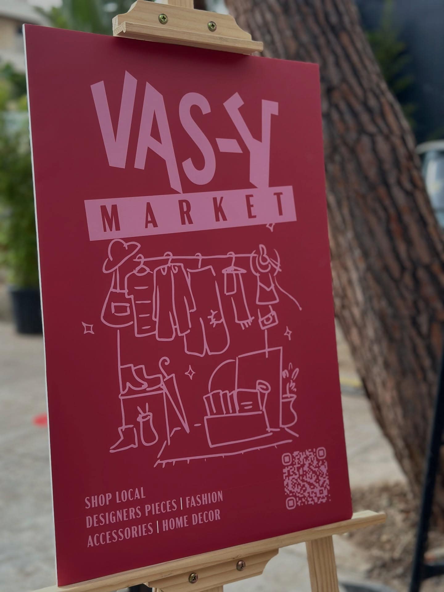 The Vas-y Market sign on an easel in the souk